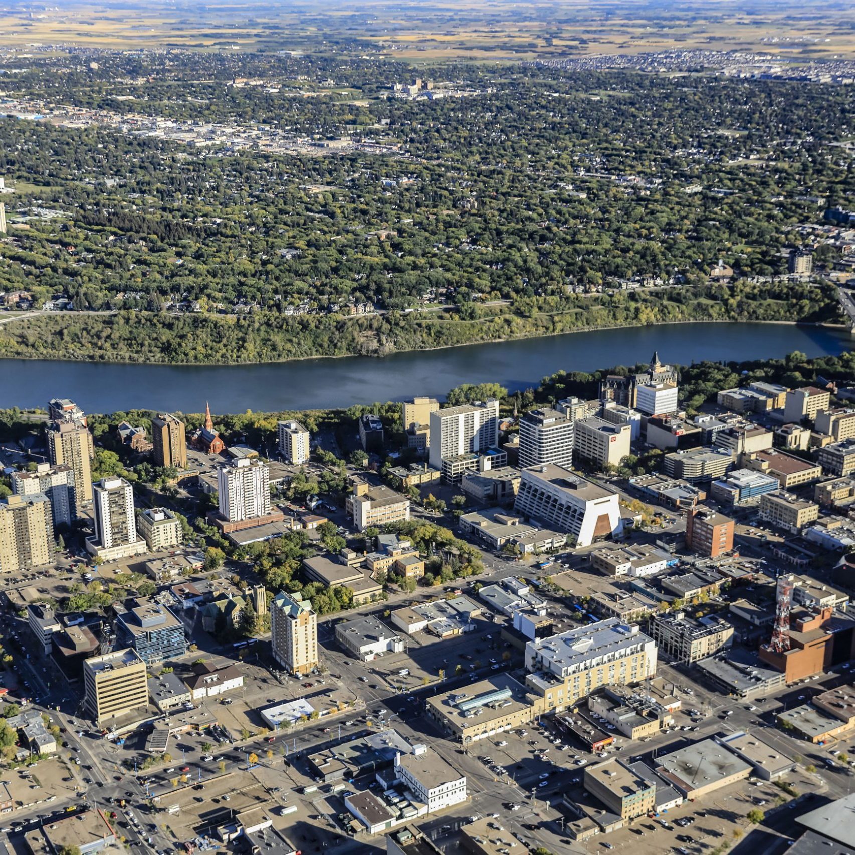 Aerial view of downtown Saskatoon, the South Saskatchewan River, and surrounding neighbourhoods.