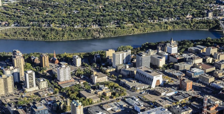 Aerial view of downtown Saskatoon, the South Saskatchewan River, and surrounding neighbourhoods.